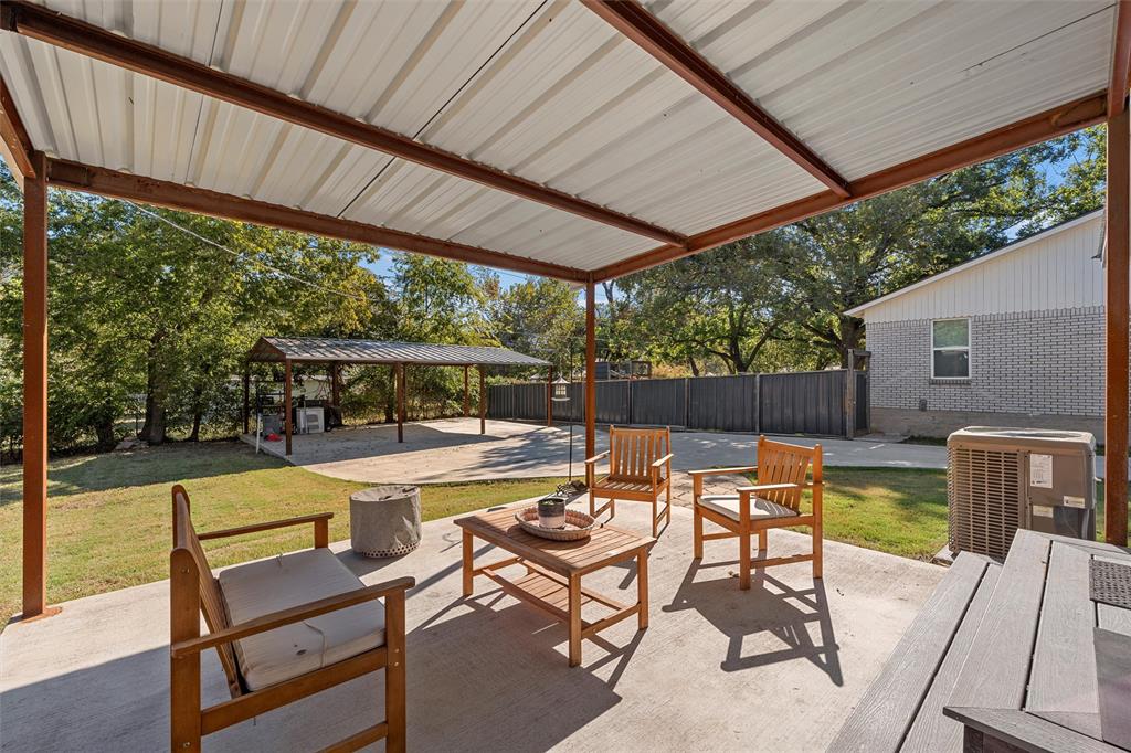 111 North Avenue R Clifton, TX 76634 - Photo 19 of 27 a view of a swimming pool with a table and chairs under an umbrella