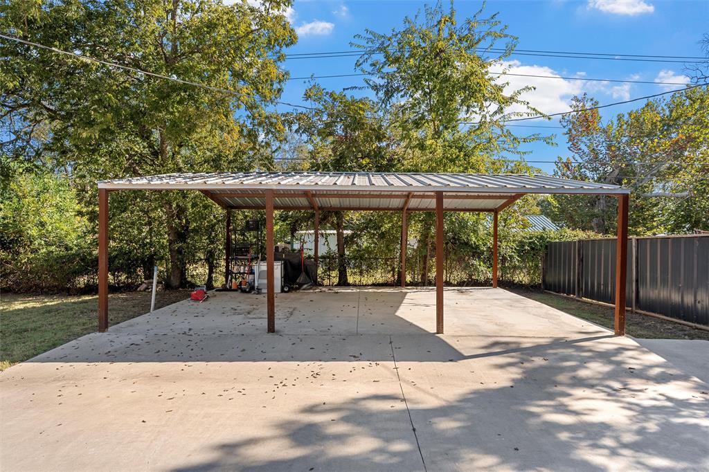 111 North Avenue R Clifton, TX 76634 - Photo 23 of 27 a view of patio with table and chairs under an umbrella