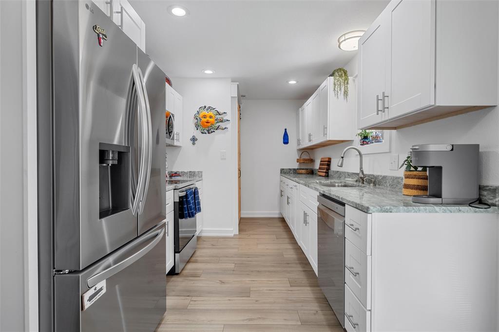 111 North Avenue R Clifton, TX 76634 - Photo 7 of 27 a kitchen with stainless steel appliances granite countertop a refrigerator and a sink