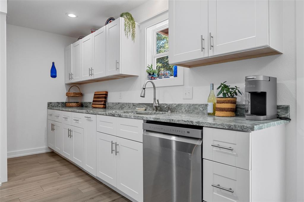 111 North Avenue R Clifton, TX 76634 - Photo 8 of 27 a kitchen with granite countertop white cabinets and white appliances