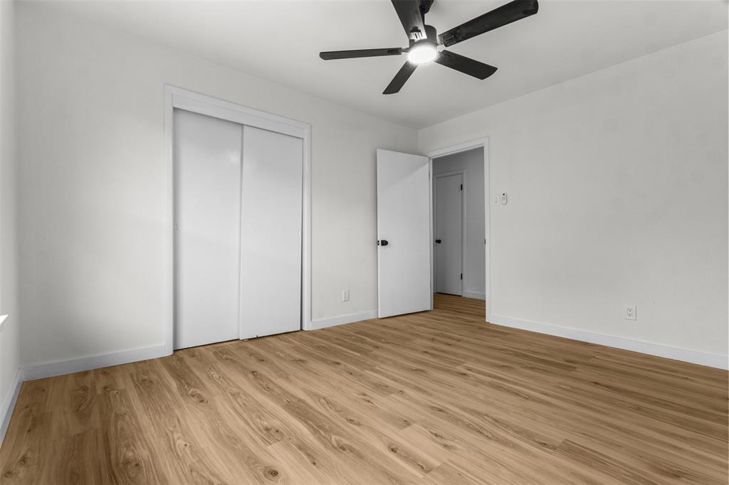1917 South Vernon Avenue Dallas, TX 75224 - Photo 21 of 28 Expansive room featuring wood-finish flooring, white walls, and a ceiling fan with integrated lighting