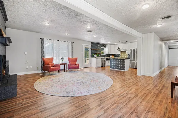 a view of a kitchen with kitchen island a counter top space a sink and appliances