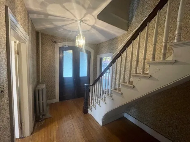 a view of staircase with railing and white walls