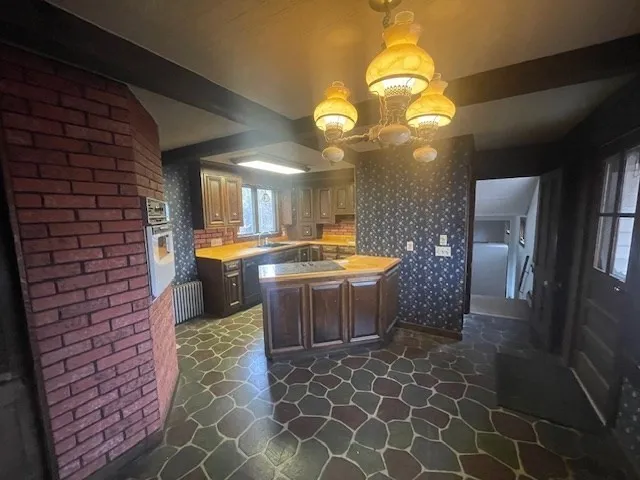 a kitchen with a refrigerator and a stove