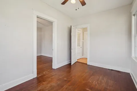 a view of wooden floor and windows in a room