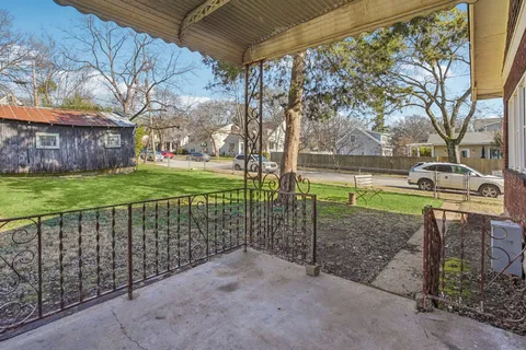 a view of a park with iron fence
