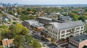 a view of hall way with furniture and chandelier