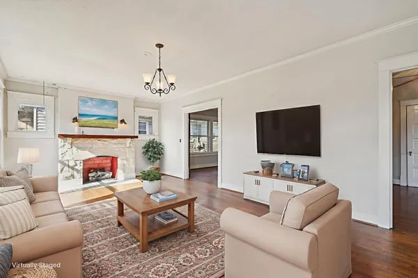a living room with furniture a fireplace and a flat screen tv