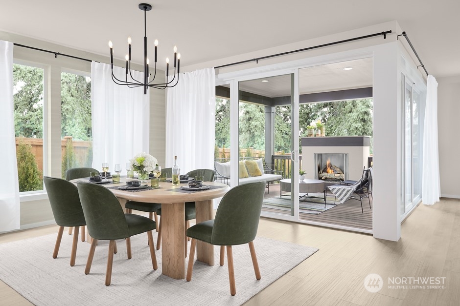 6555 Southeast 8th Street Renton, WA 98059 - Photo 4 of 11 a view of a dining room with furniture wooden floor and chandelier