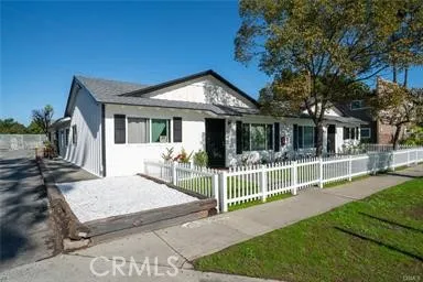 a view of a house with a small yard and deck