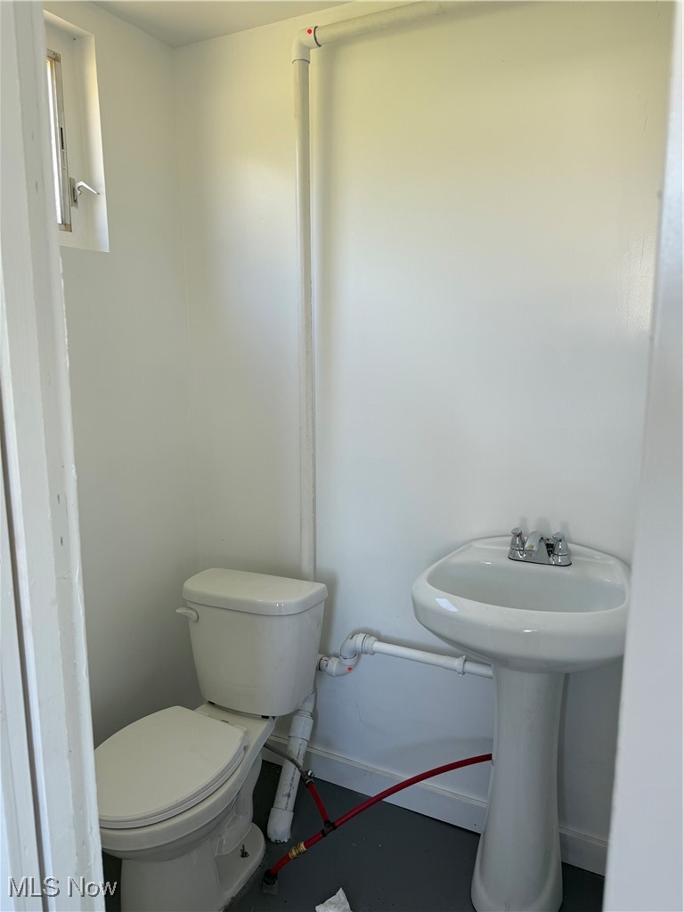 4394 Lake Road East Geneva, OH 44041 - Photo 4 of 13 Half bathroom with toilet and baseboards