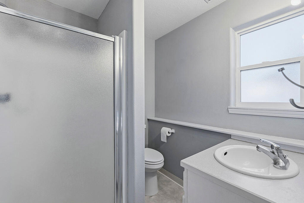 2979 Northeast Sugar Pine Road Prineville, OR 97754 - Photo 16 of 31 a bathroom with a toilet a sink and a mirror