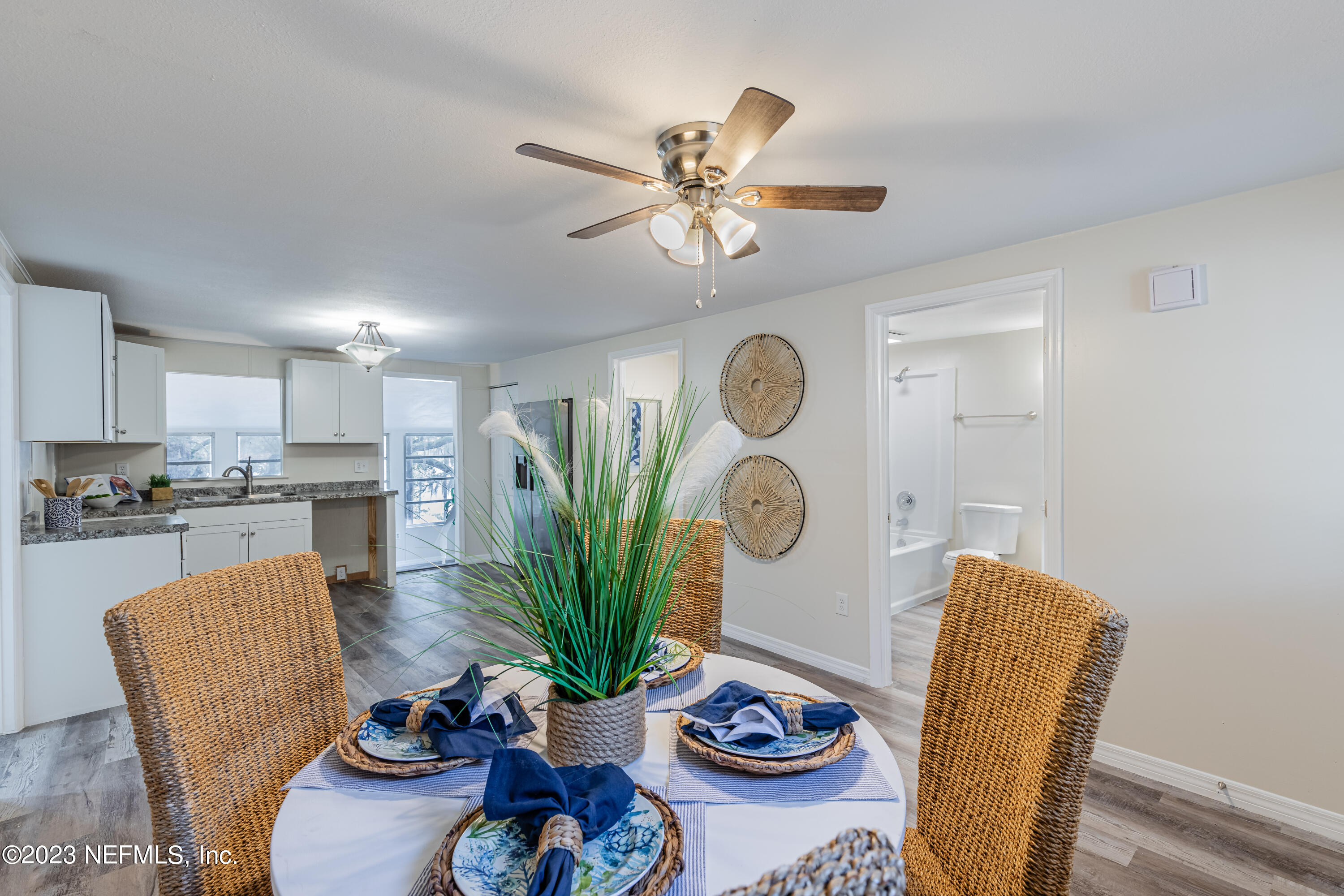 6189 Little Lake Geneva Road Keystone Heights, FL 32656 - Photo 16 of 40 a dining room with furniture a kitchen view and wooden floor