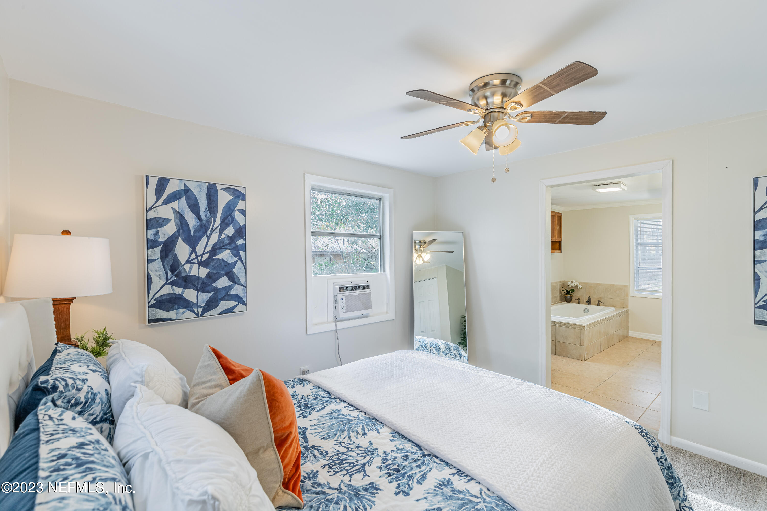 6189 Little Lake Geneva Road Keystone Heights, FL 32656 - Photo 29 of 40 a bedroom with a bed and a chandelier