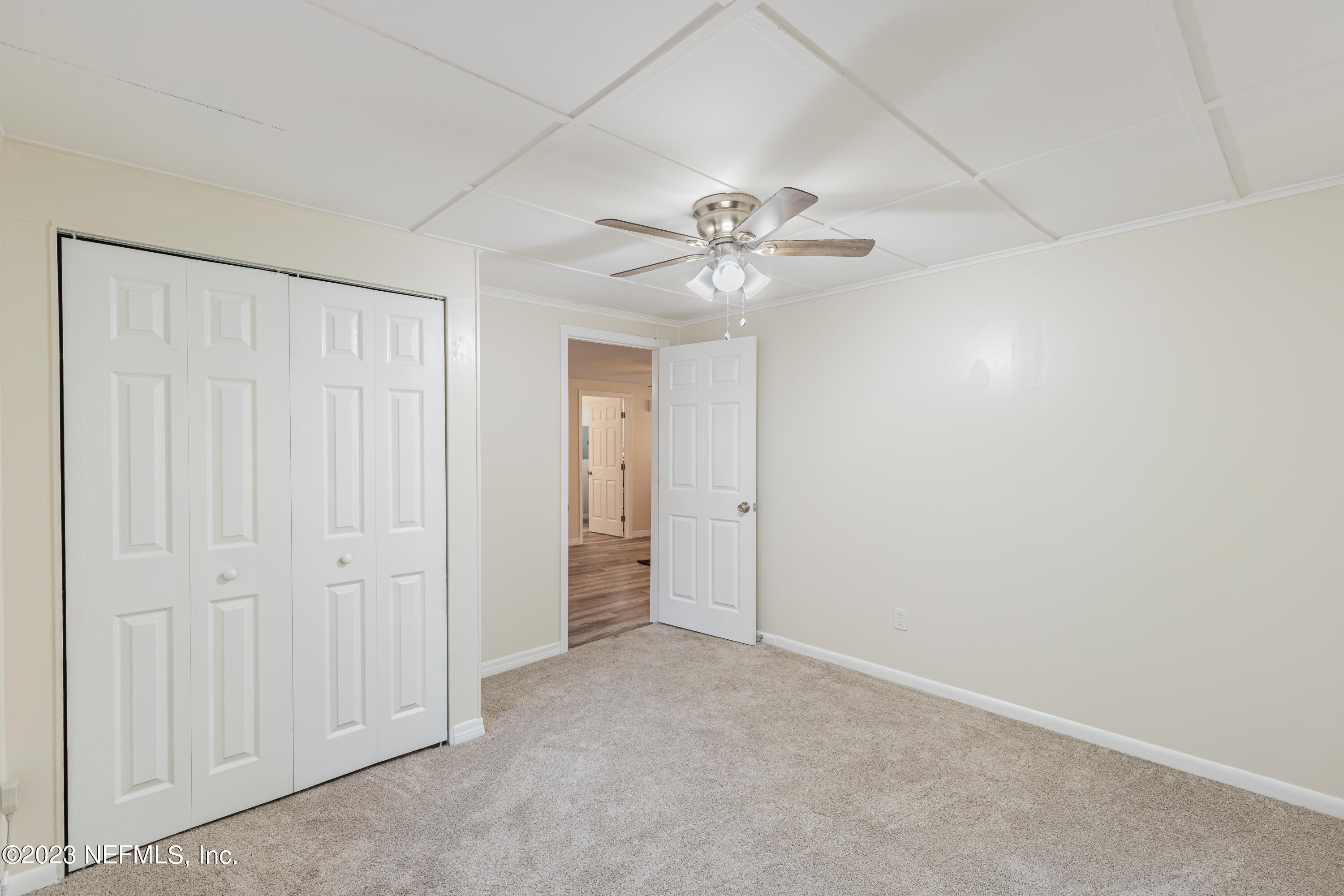 6189 Little Lake Geneva Road Keystone Heights, FL 32656 - Photo 33 of 40 an empty room with a chandelier fan and closet