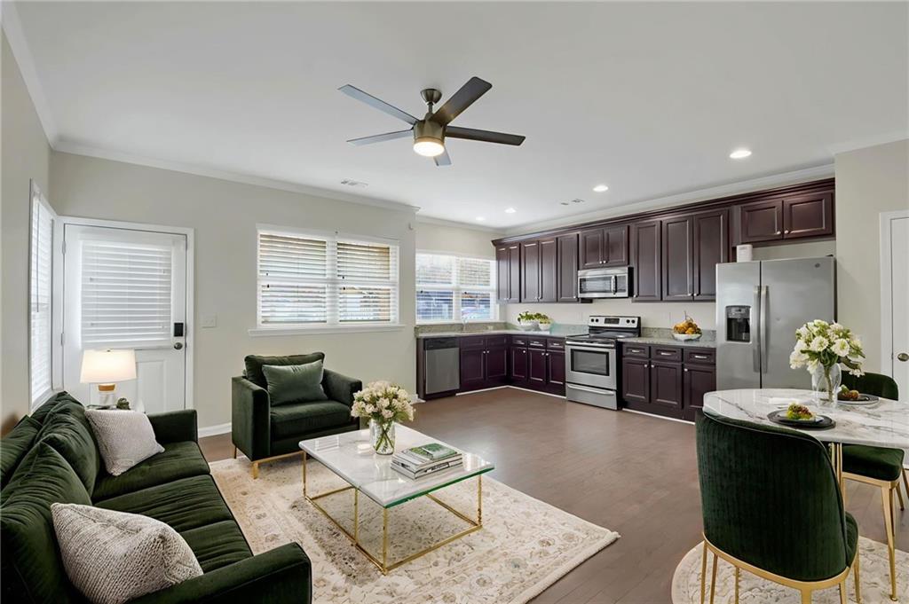 a living room with furniture kitchen view and a window