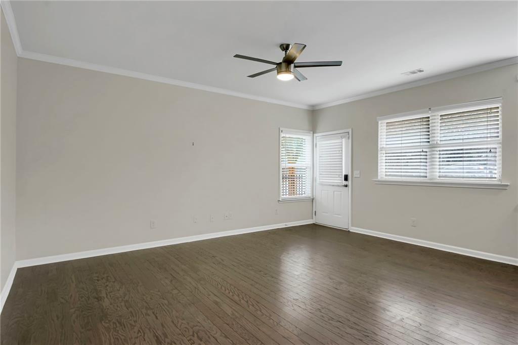 2042 Bolton Road Northwest Atlanta, GA 30318 - Photo 11 of 30 a view of empty room with wooden floor and fan