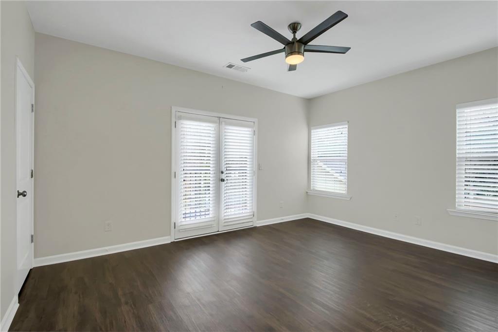 2042 Bolton Road Northwest Atlanta, GA 30318 - Photo 14 of 30 an empty room with wooden floor and windows
