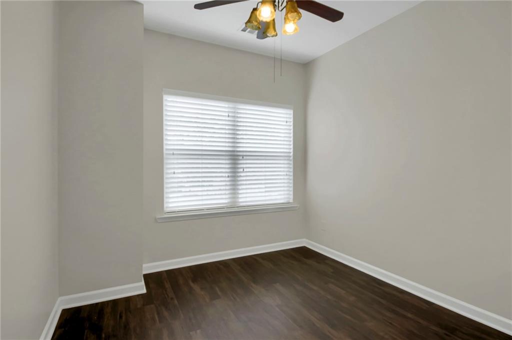 2042 Bolton Road Northwest Atlanta, GA 30318 - Photo 20 of 30 an empty room with a window and wooden floor
