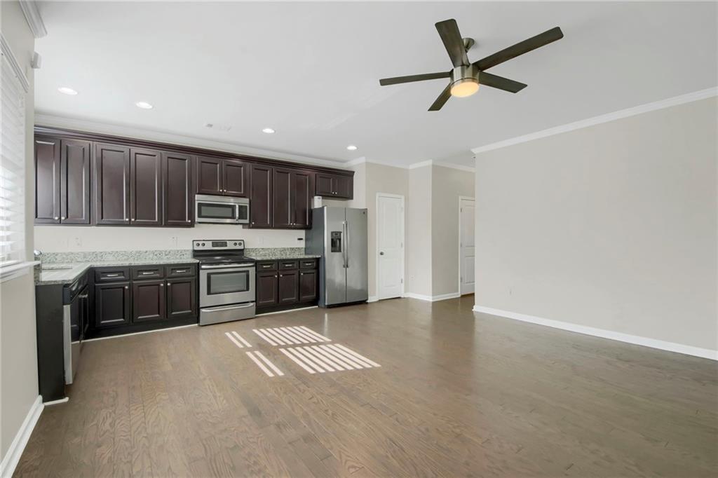 2042 Bolton Road Northwest Atlanta, GA 30318 - Photo 5 of 30 a kitchen with stainless steel appliances a refrigerator sink and cabinets
