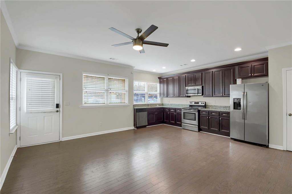 2042 Bolton Road Northwest Atlanta, GA 30318 - Photo 6 of 30 a kitchen with stainless steel appliances a refrigerator and a stove top oven