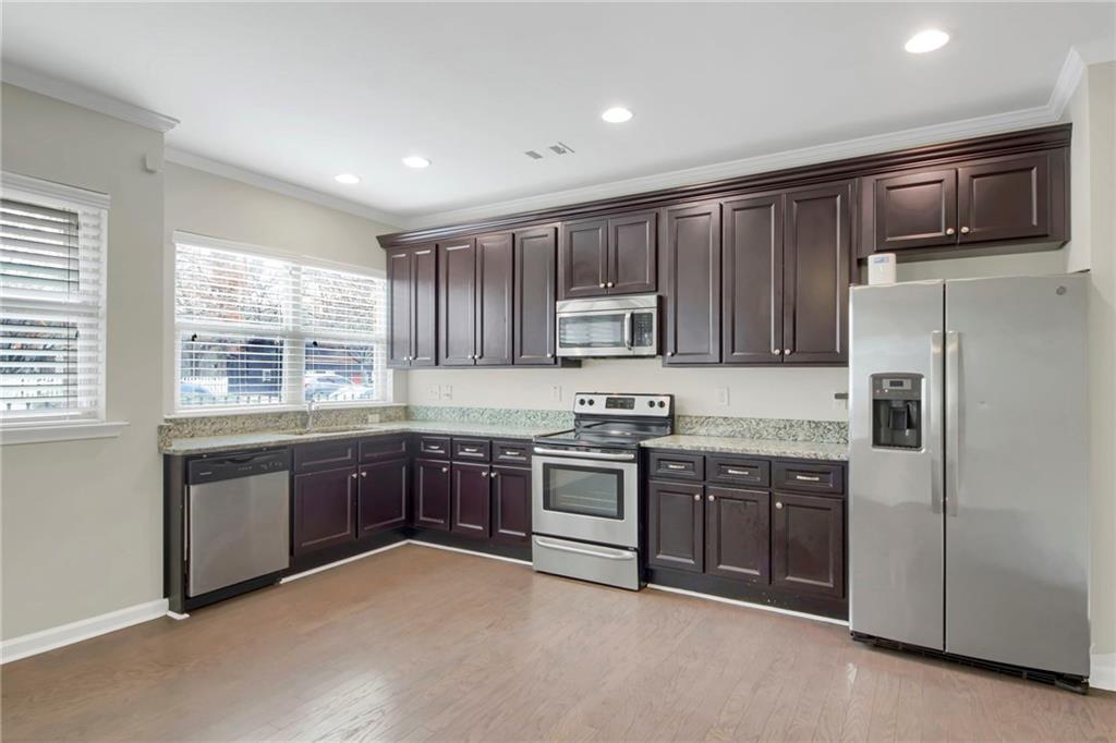 2042 Bolton Road Northwest Atlanta, GA 30318 - Photo 7 of 30 a kitchen with stainless steel appliances granite countertop a stove a sink dishwasher a refrigerator and a microwave oven