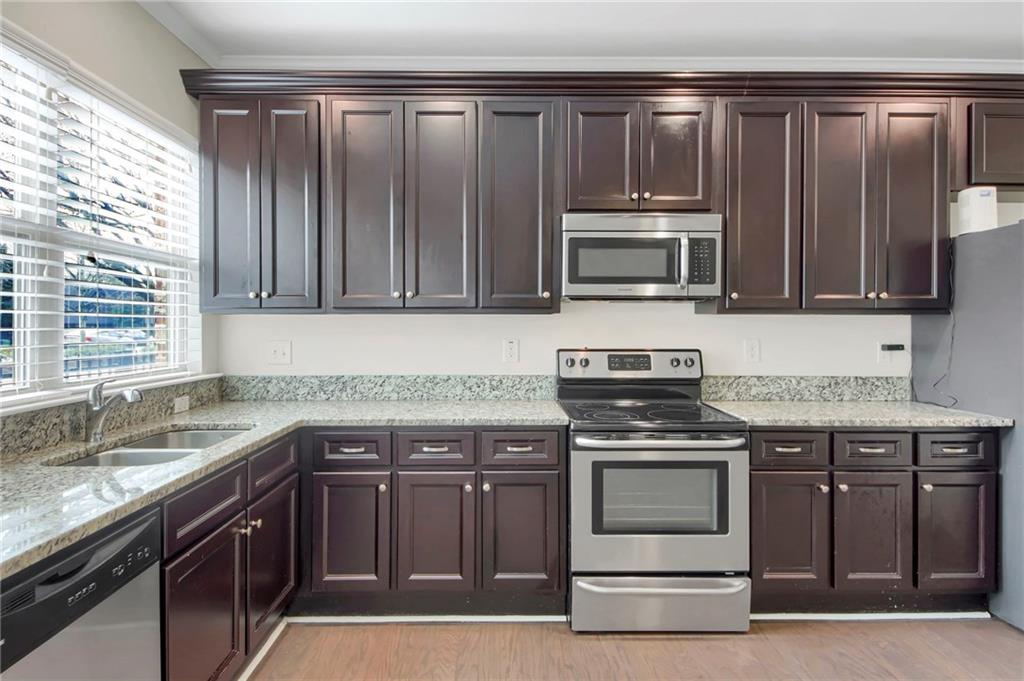 2042 Bolton Road Northwest Atlanta, GA 30318 - Photo 9 of 30 a kitchen with granite countertop a stove and a sink