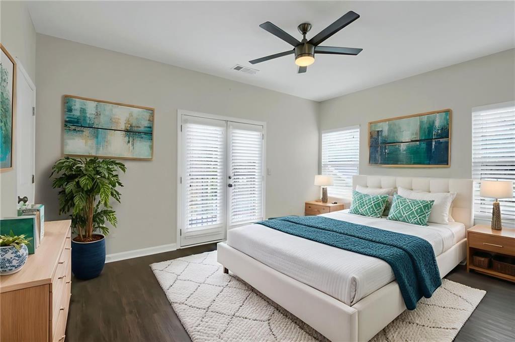 2042 Bolton Road Northwest Atlanta, GA 30318 - Photo 10 of 30 a bedroom with a large bed and a potted plant