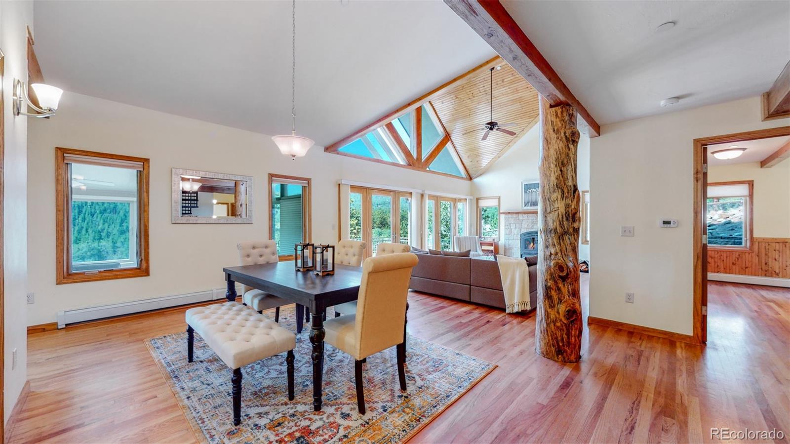 153 Ski Road East Allenspark, CO 80510 - Photo 12 of 40 a dining room with furniture window and wooden floor