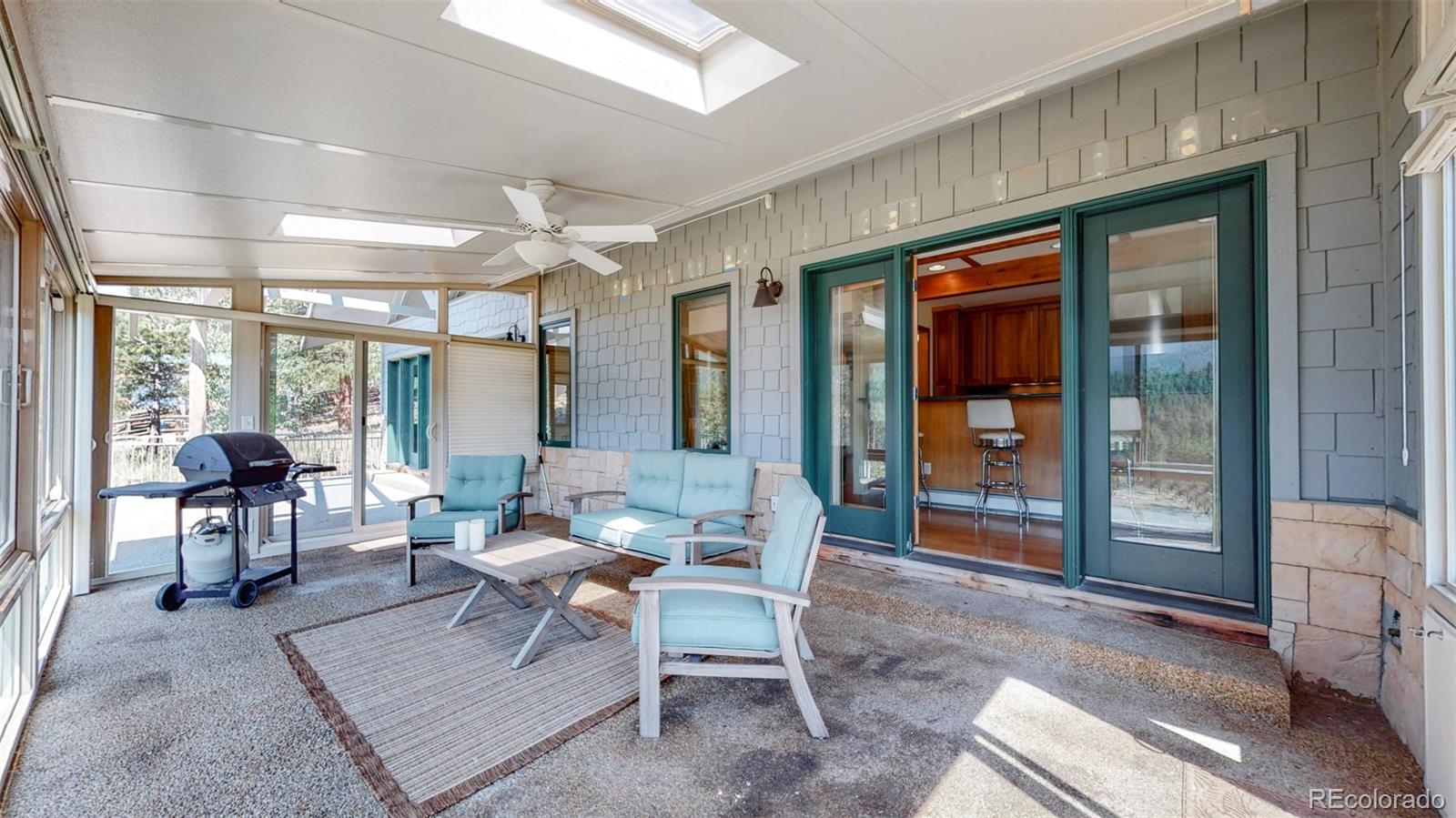 153 Ski Road East Allenspark, CO 80510 - Photo 18 of 40 a living room with furniture a rug and a large window