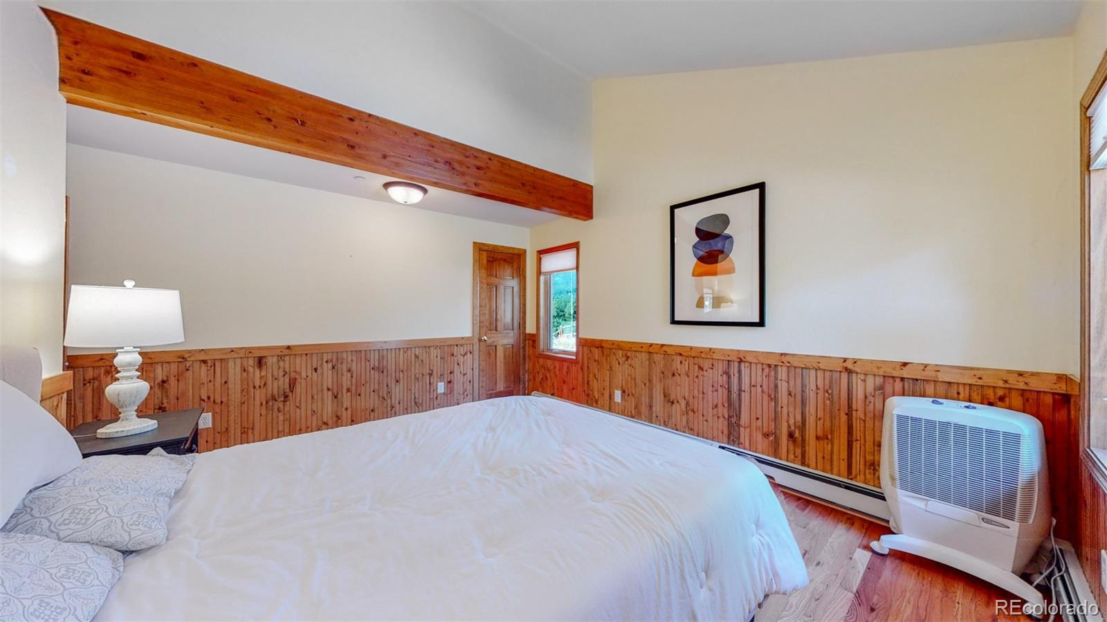 153 Ski Road East Allenspark, CO 80510 - Photo 23 of 40 a bedroom with a large bed and a window