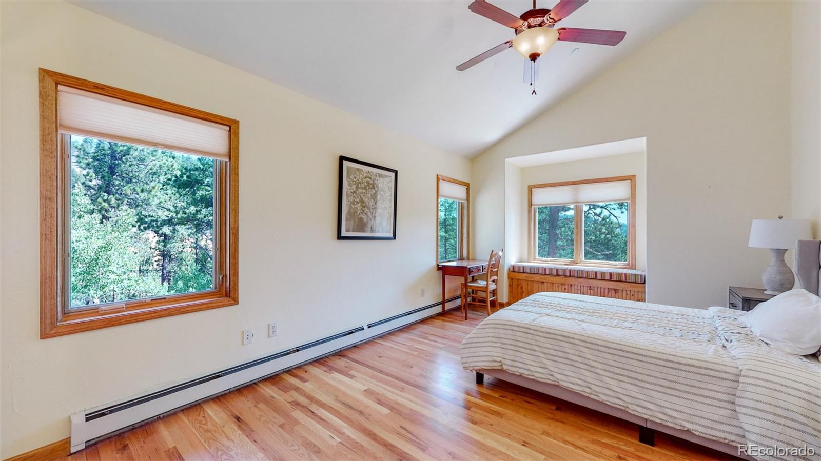 153 Ski Road East Allenspark, CO 80510 - Photo 24 of 40 a bedroom with a bed and wooden floor