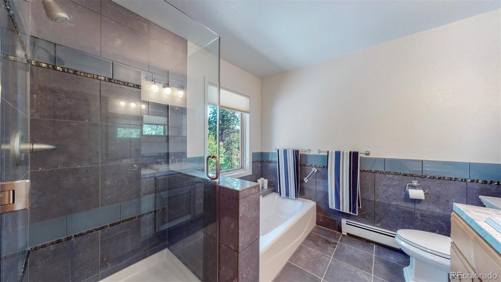 153 Ski Road East Allenspark, CO 80510 - Photo 25 of 40 a bathroom with a bathtub and a shower