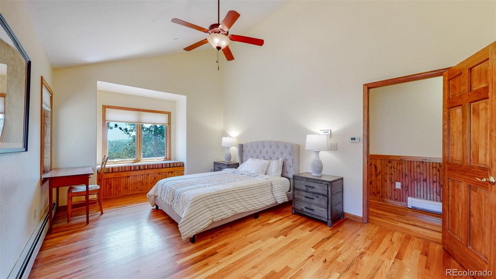 153 Ski Road East Allenspark, CO 80510 - Photo 26 of 40 a bedroom with a bed and a chandelier