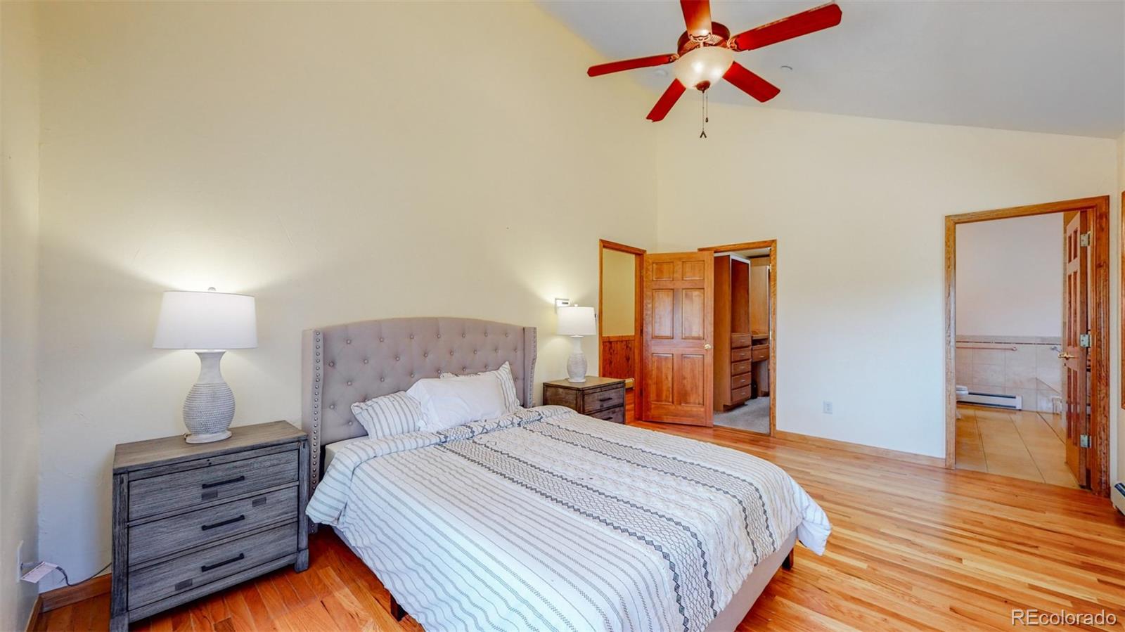 153 Ski Road East Allenspark, CO 80510 - Photo 27 of 40 a bedroom with a bed and wooden floor