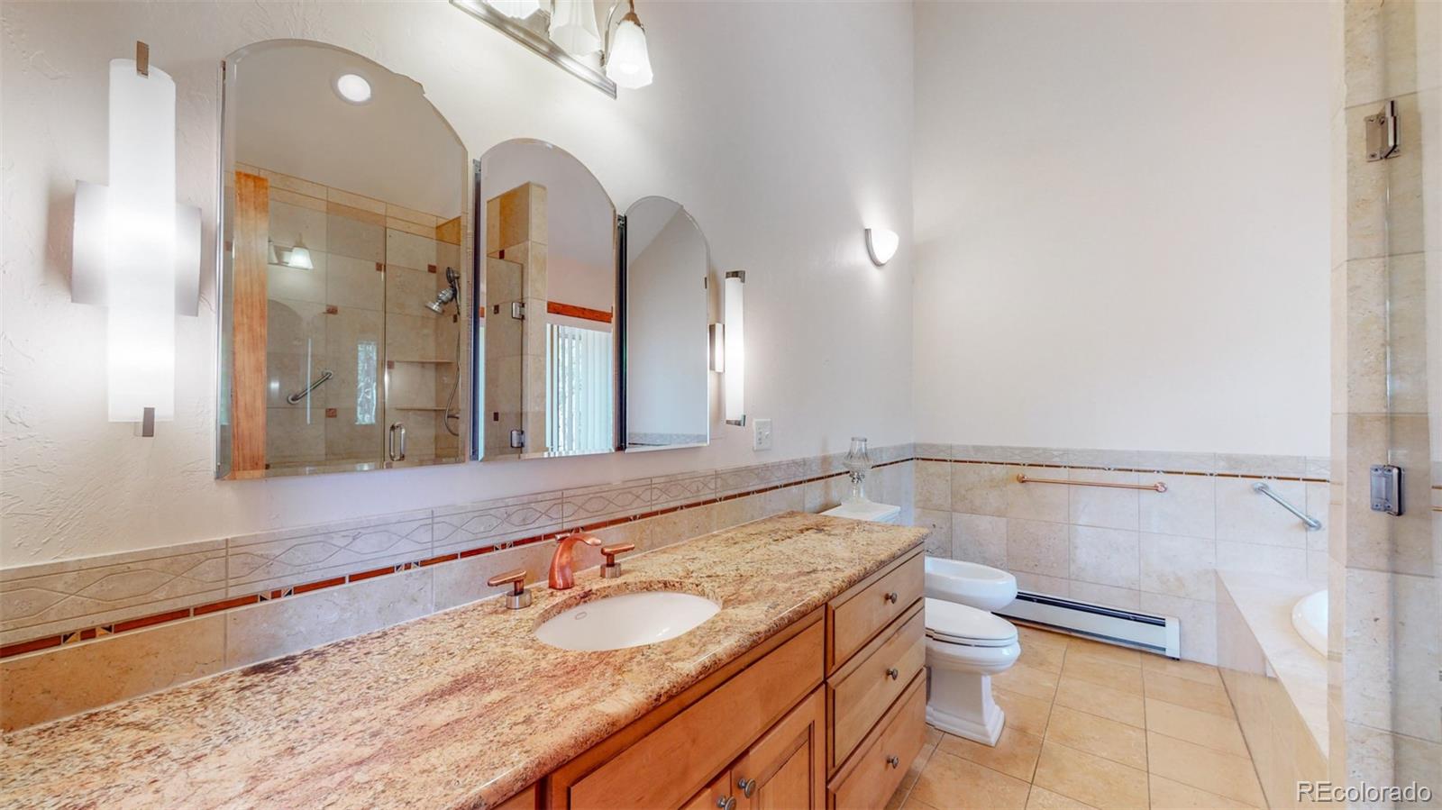 153 Ski Road East Allenspark, CO 80510 - Photo 29 of 40 a bathroom with a granite countertop sink and a mirror