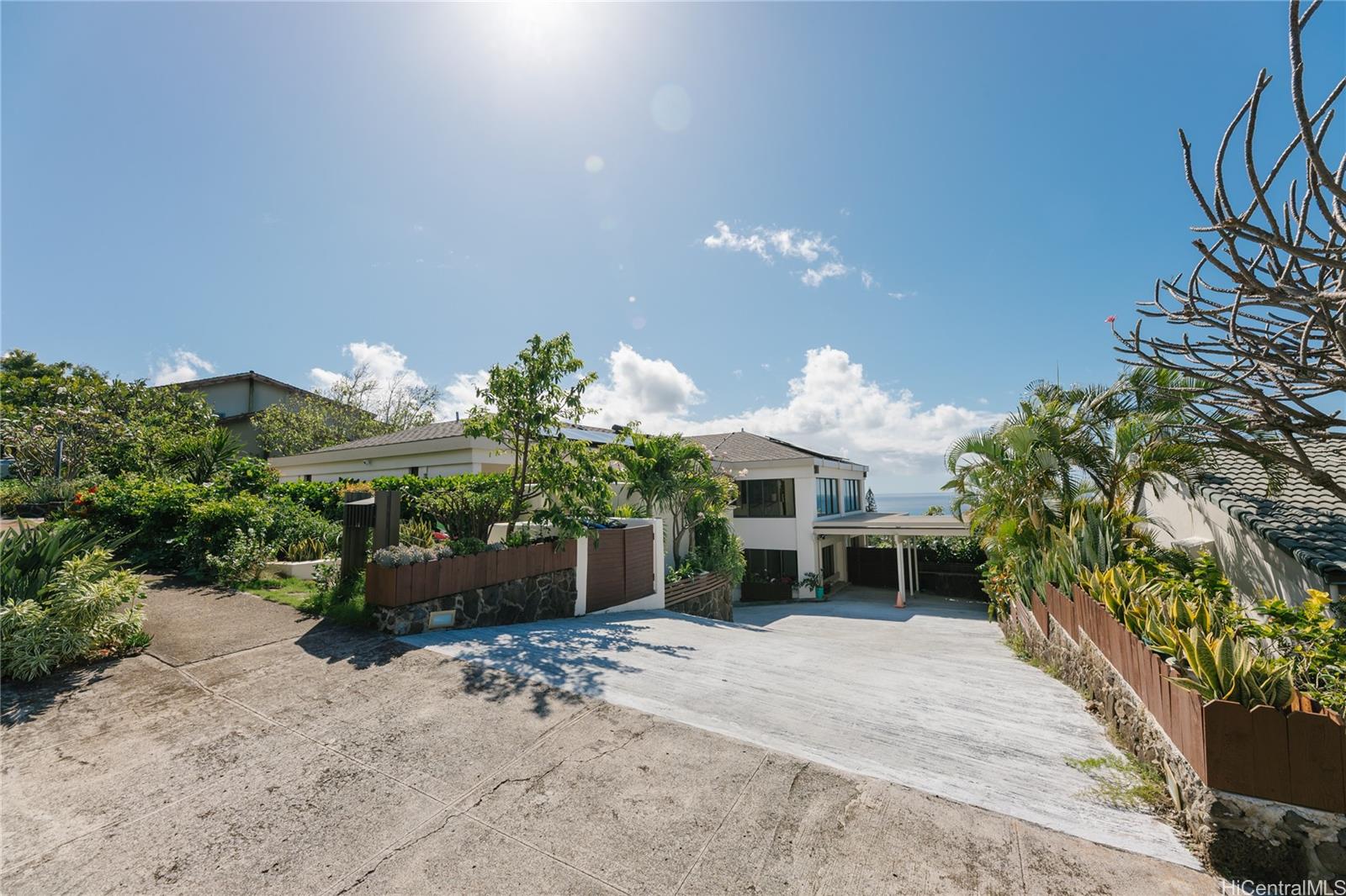 1632 Ihiloa Loop Honolulu, HI 96821 - Photo 2 of 24 a front view of a house with a yard and a garden