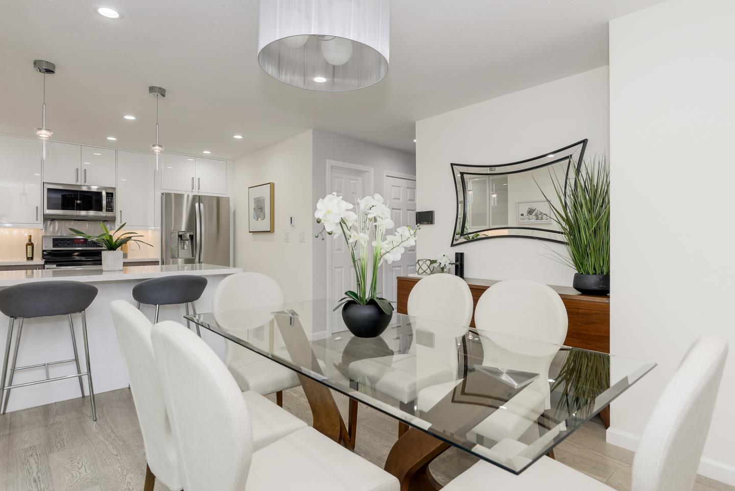 33 Park Road, Unit 10 Burlingame, CA 94010 - Photo 15 of 41 a kitchen with stainless steel appliances a dining table chairs and living room view