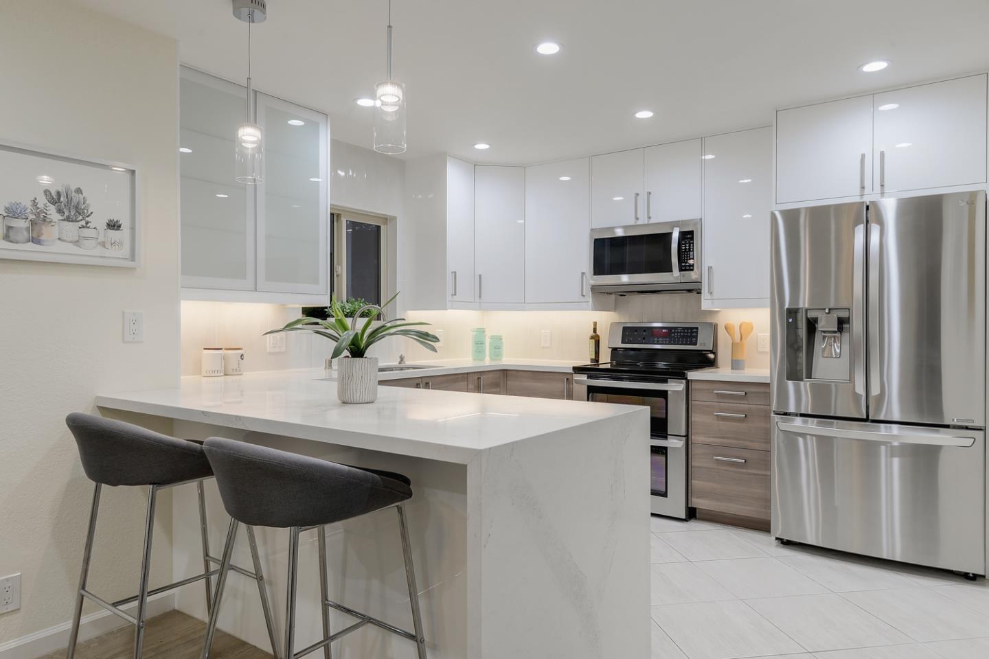 33 Park Road, Unit 10 Burlingame, CA 94010 - Photo 16 of 41 a kitchen with appliances a sink and a refrigerator