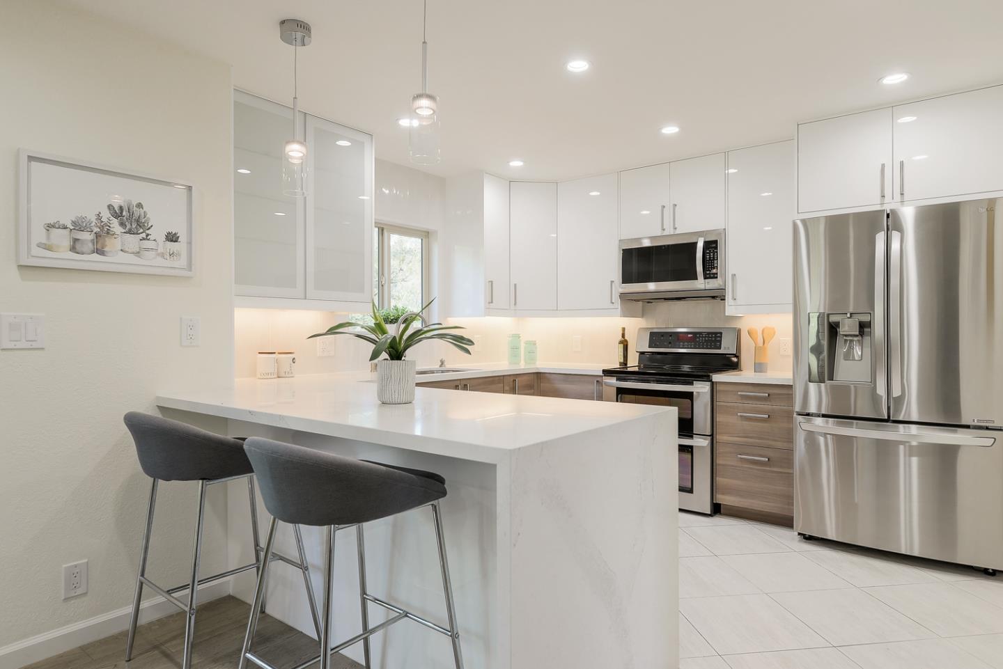 33 Park Road, Unit 10 Burlingame, CA 94010 - Photo 17 of 41 a kitchen with stainless steel appliances kitchen island a refrigerator and a sink