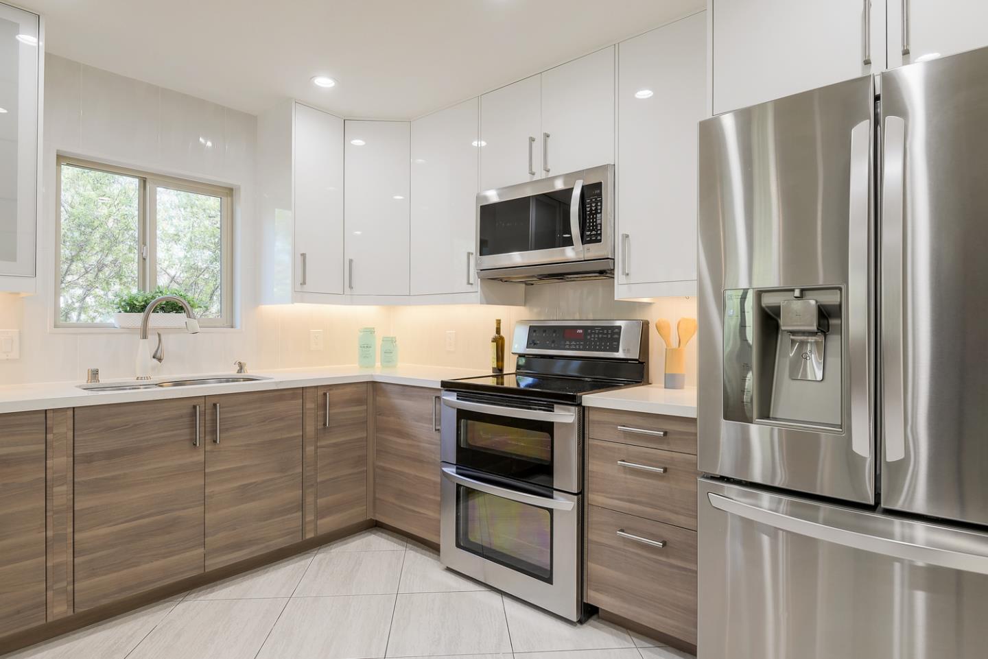 33 Park Road, Unit 10 Burlingame, CA 94010 - Photo 18 of 41 a kitchen with stainless steel appliances a refrigerator sink and microwave