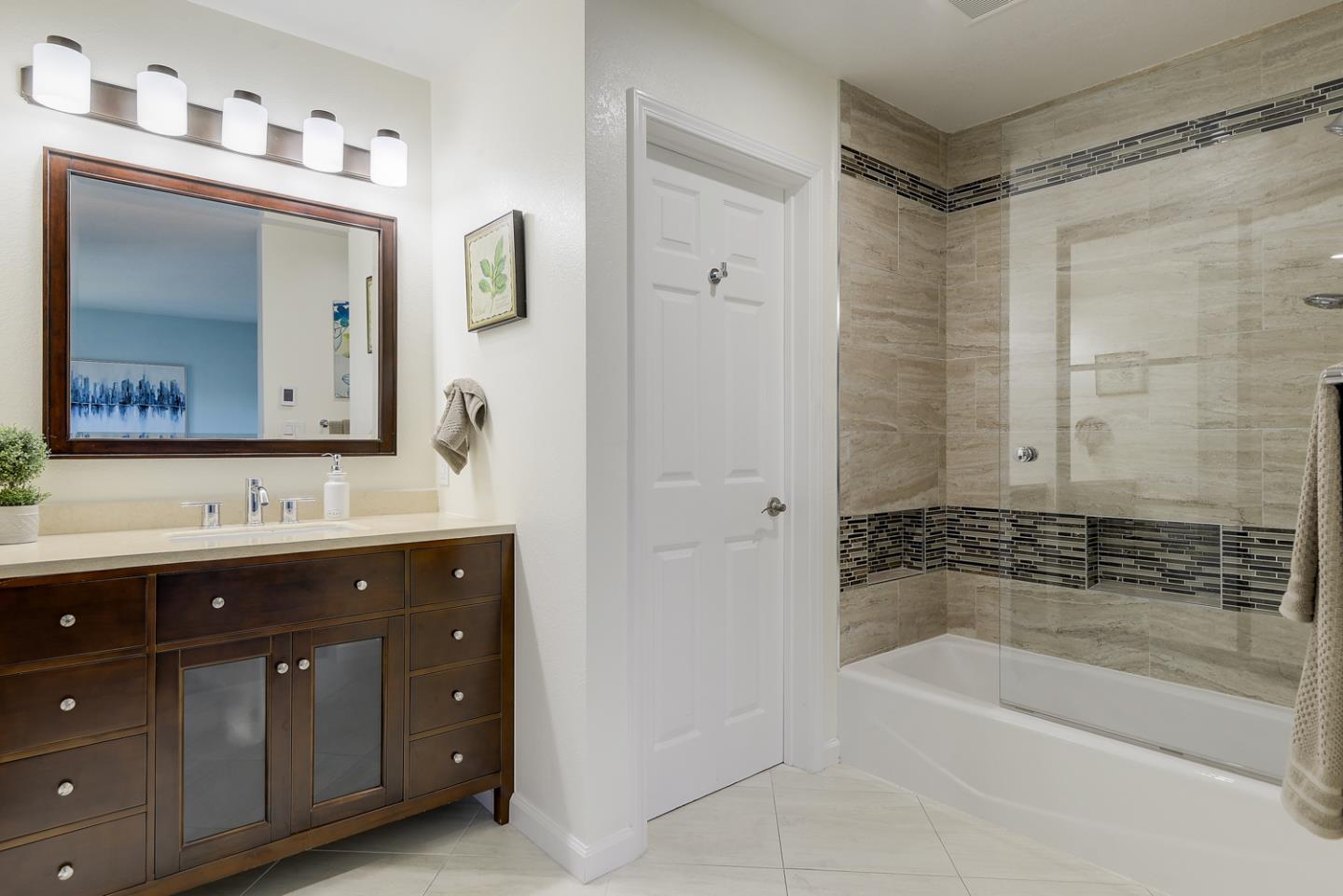 33 Park Road, Unit 10 Burlingame, CA 94010 - Photo 33 of 41 a bathroom with a tub a sink and mirror