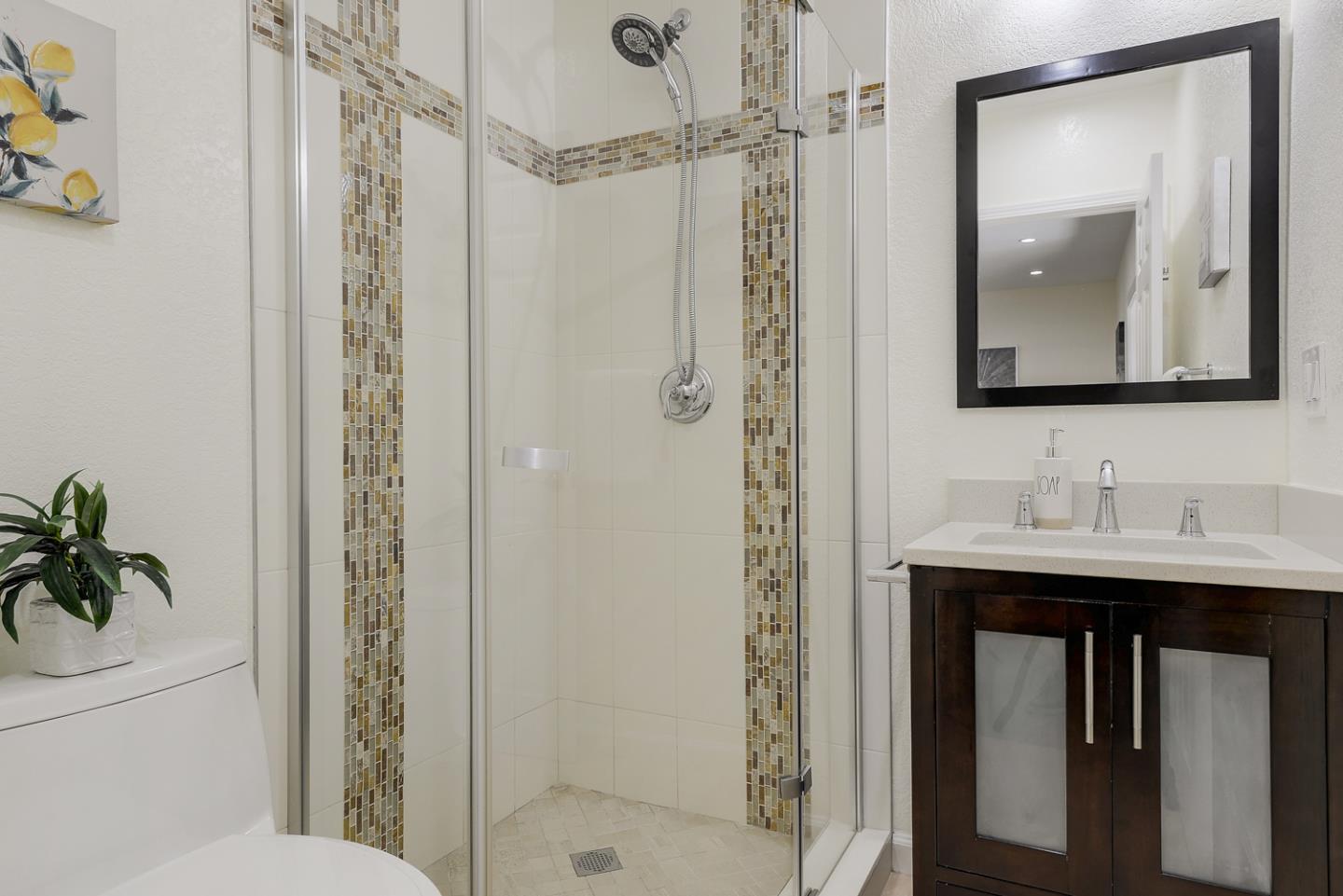 33 Park Road, Unit 10 Burlingame, CA 94010 - Photo 34 of 41 a bathroom with a toilet a sink and a mirror