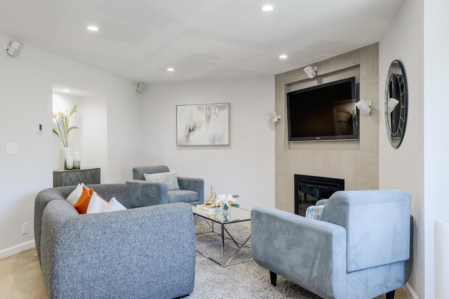 33 Park Road, Unit 10 Burlingame, CA 94010 - Photo 9 of 41 a living room with furniture a flat screen tv and a fireplace