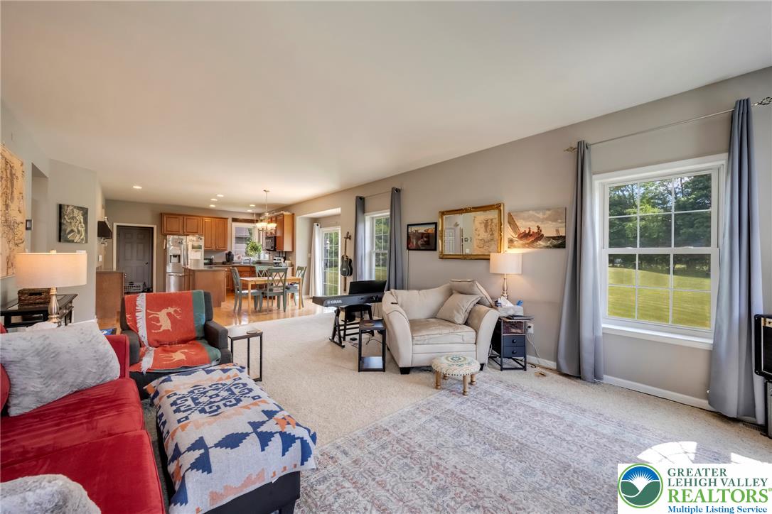 204 Bushkill Ridge Road Wind Gap, PA 18091 - Photo 15 of 48 An open-concept layout unites the comfortable living room with the functional kitchen and dining area, creating a harmonious flow.