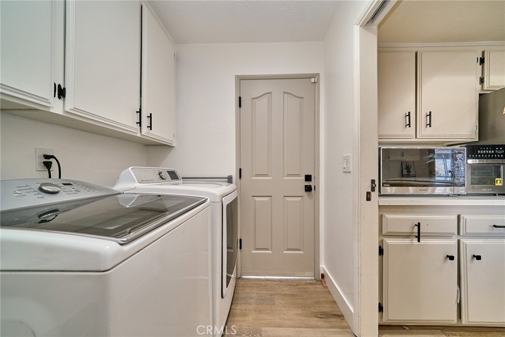 9783 Corton Street Phelan, CA 92371 - Photo 15 of 29 a kitchen with white cabinets sink and dishwasher