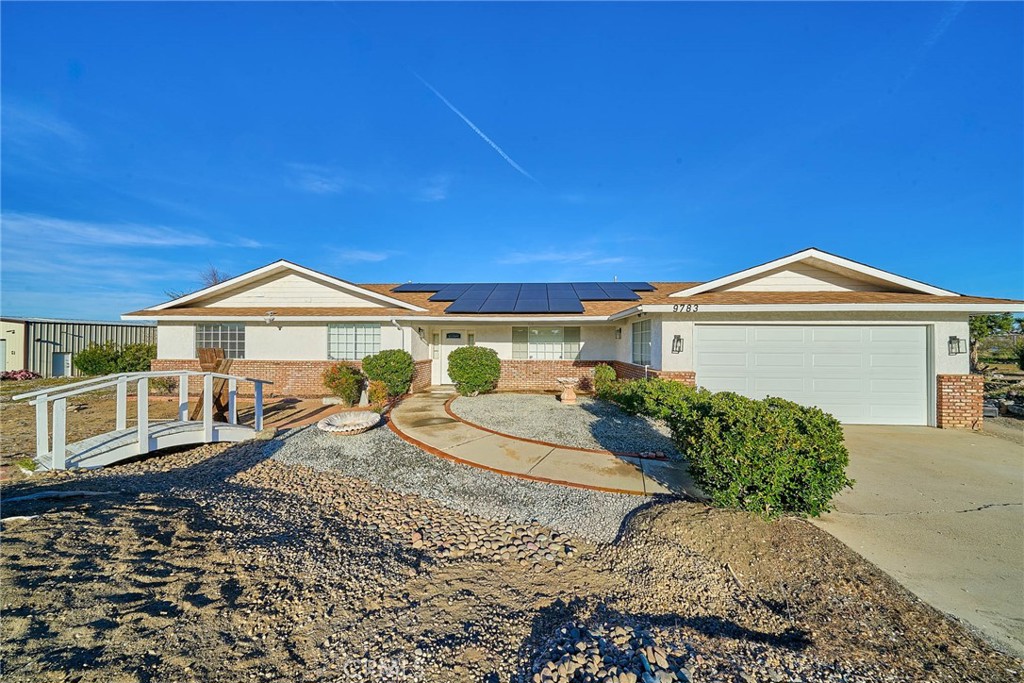 9783 Corton Street Phelan, CA 92371 - Photo 4 of 29 a front view of a house with a yard