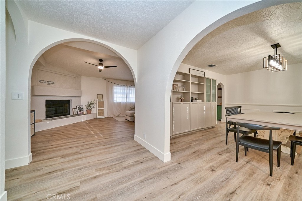 9783 Corton Street Phelan, CA 92371 - Photo 9 of 29 a living room with furniture wooden floor and a fireplace