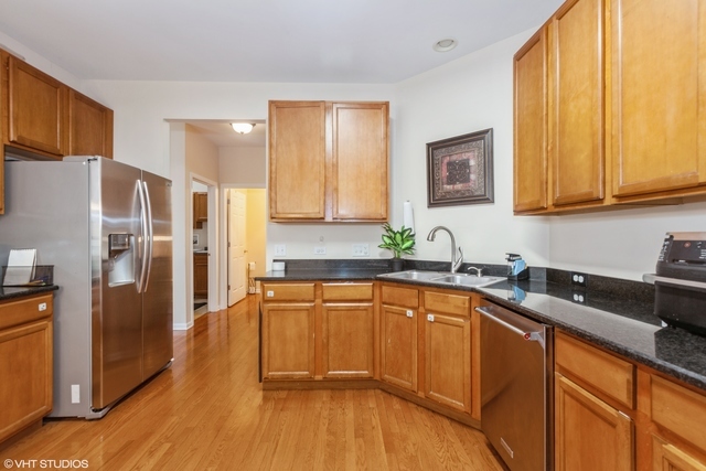 152 Orchards Pass Bartlett, IL 60103 - Photo 11 of 40 a kitchen with stainless steel appliances granite countertop a refrigerator sink and cabinets