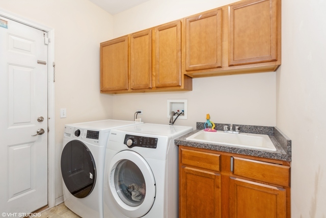 152 Orchards Pass Bartlett, IL 60103 - Photo 12 of 40 a utility room with dryer and washer